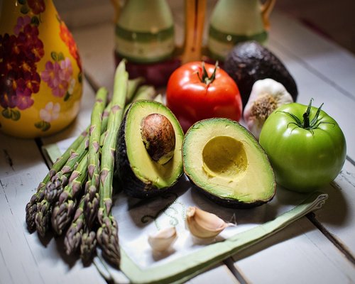 A well-balanced colorful food plate featuring avocado and fresh ingredients